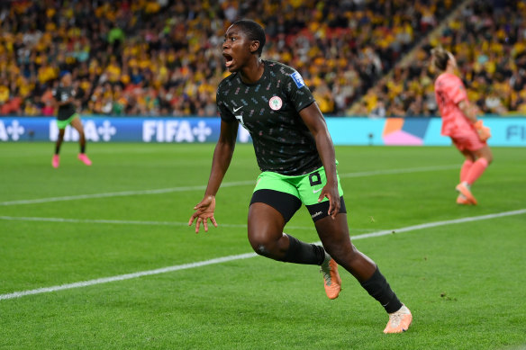 Asisat Oshoala celebrates after scoring for Nigeria.