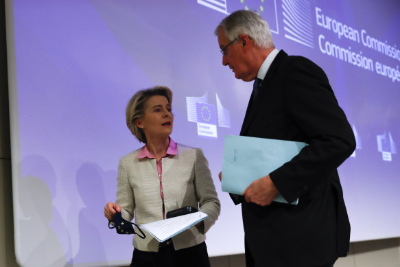 Michel Barnier, right, speaks with European Commission President Ursula von der Leyen after the deal was announced.