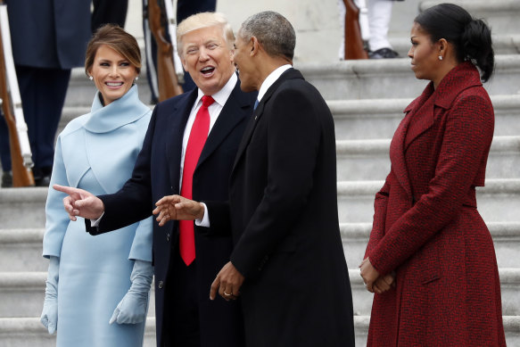 Michelle Obama (right) sported a ‘casual’ hairdo at Donald Trump’s Presidential inauguration in 2017.