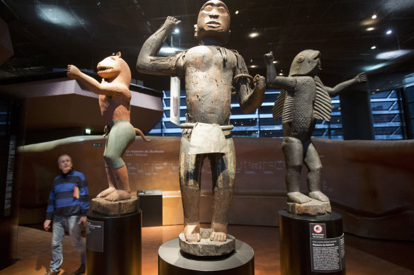 Wooden royal statues of the Dahomey kingdom , today's Benin, on display at Quai Branly museum in Paris.