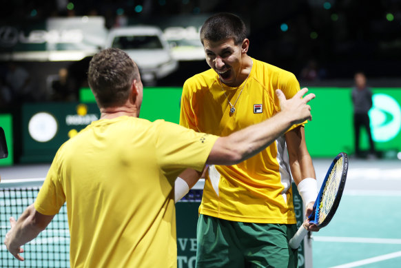Alexei Popyrin celebrates with Australian captain Lleyton Hewitt after his Davis Cup win.