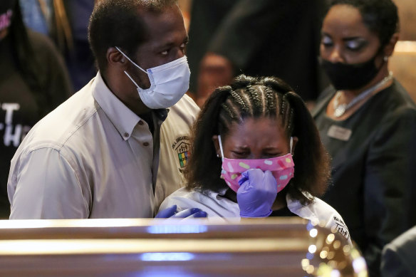 Mourners react as they visit the casket of George Floyd in Houston on Monday.