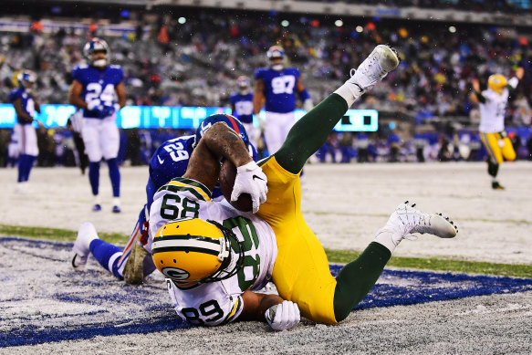 Let it snow: Green Bay's Marcedes Lewis scores a touchdown in the second half against the New York Giants. 