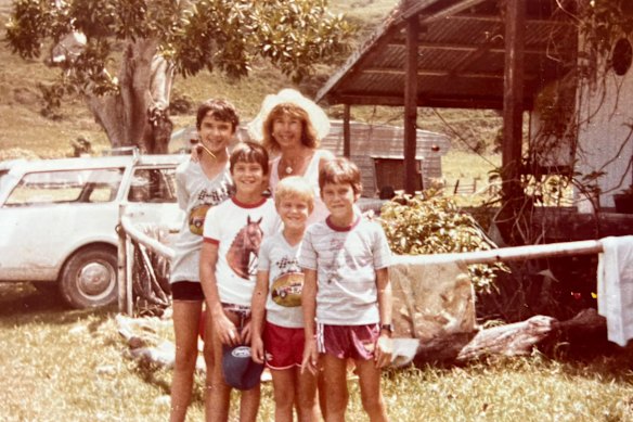 The author (far right) with his three brothers and mother outside their old farmhouse.