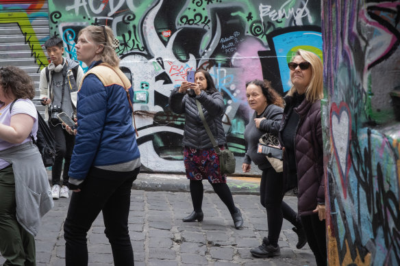 Visitors to Hosier Lane stream past the junction of Rutledge Lane where some drug usage occurs.