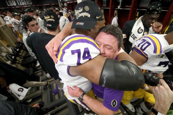 LSU head coach Ed Orgeron hugs offensive tackle Badara Traore in the winning change-room.