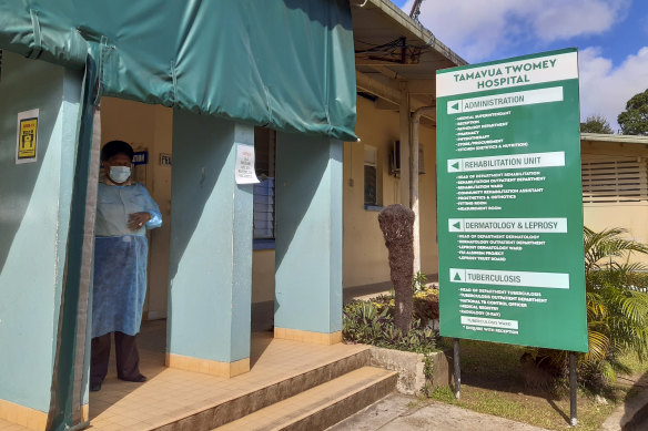 A nurse stands outside Tamara Twomey hospital in Suva, Fiji. A growing COVID outbreak has stretched the island nation’s health system.