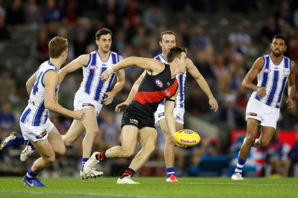 Zach Merrett looks to get the ball away for the Bombers on Sunday.