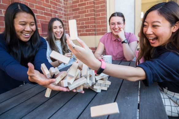 Access Health mental health and alcohol and drug clinicians Yoshe Le, Gabrielle Klepfisz, Carissa Mirra and Ly-Huong Tran (left to right) playing Jenga. 