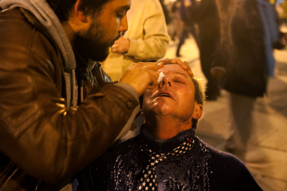 A protester receives help washing pepper spray out of his eyes on the night of US President Donald Trump’s inauguration.