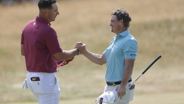 Lucas Herbert of Australia, left shakes hands with Bud Cauley.
