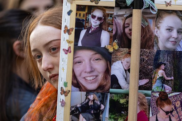 A woman with pictures of Isla Bell outside the Supreme Court at a gathering of her loved ones and supporters.