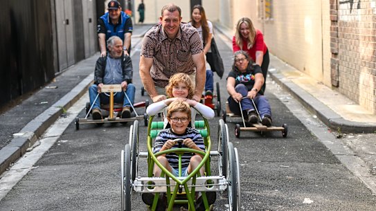 Pete Furlong with his kids, Orly and Lenni, lead a pack of Queensberry Cup billycart racers.
