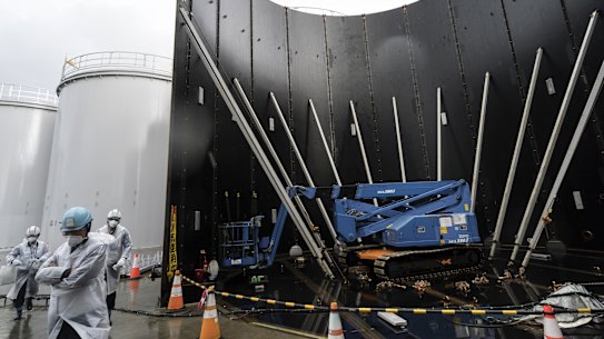 A media tour passes the Tokyo Electric Power Co's storage tank for radioactive water under construction at the Fukushima Dai-ichi nuclear power plant on January 29. The plant was wrecked by an earthquake and tsunami in 2011. 