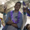 A supporter plays with a cardboard cutout of Daniel Noboa as she celebrates the early election results in Quito, Ecuador.
