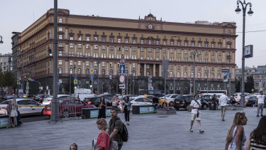 People walk at Lubyanka Square with the building of the Federal Security Service, the successor the KGB in in Moscow.
