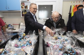 Anthony Albanese and Father Bob Maguire viewing the packed chocolate Easter eggs during a visit to the Father Bob Maguire Foundation in South Melbourne on Tuesday.