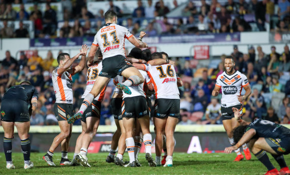 What a win: The Tigers celebrate their victory in golden point time after a field goal by Benji Marshall.