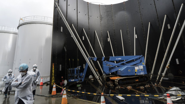 A media tour passes the Tokyo Electric Power Co's storage tank for radioactive water under construction at the Fukushima Dai-ichi nuclear power plant on January 29. The plant was wrecked by an earthquake and tsunami in 2011. 