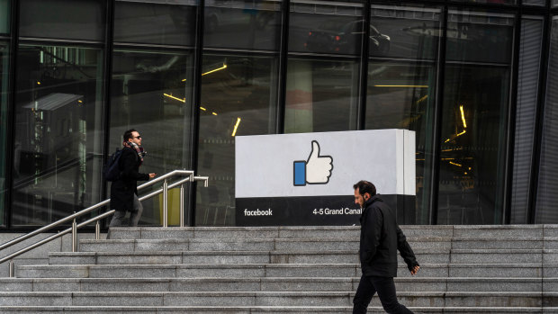 A pedestrian passes the entrance to the Facebook.