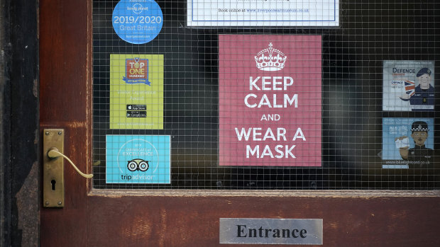 A 'Keep Calm And Wear A Face Mask' sign adorns a door in central Liverpool.