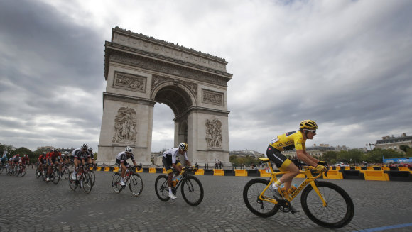 Yellow jersey Geraint Thomas, riding for Team Sky, loops around the Arc de Triomphe en route to victory in the 2018 Tour de France on Sunday.