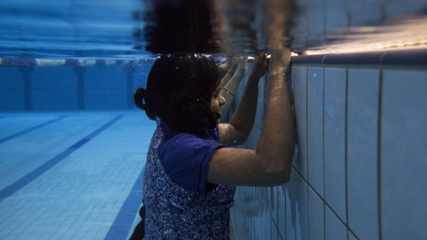 Tanya Schmid gives Chitrakala Sowrirajalu a swimming lesson at the Aquatic Safety Training Academy in Seven Hills. 