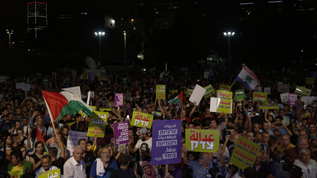 People march during a protest against the Jewish nation bill in Tel Aviv.