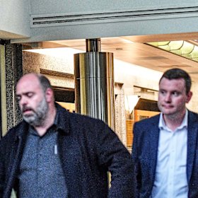 Australian Workers Union boss Ben Davis and state MP Tim Richardson leave Kim Carr’s office after the peace talks.