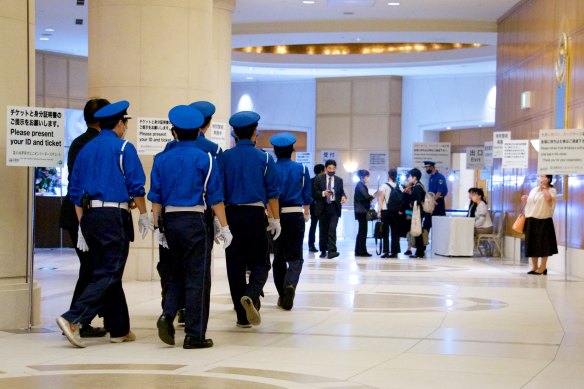 Security personnel arrive at the reception area for the World Opinion Leaders forum on Thursday night. 