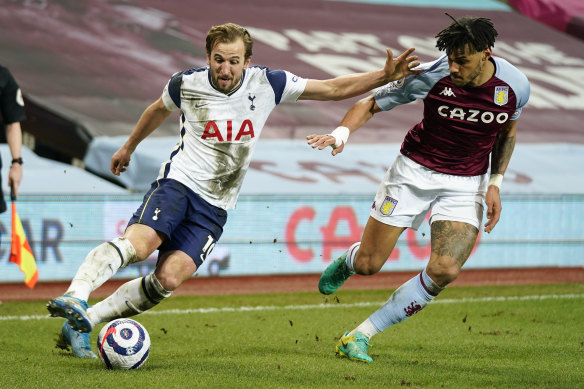 Harry Kane looks to take the ball past Aston Villa’s Tyrone Mings.