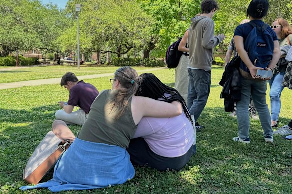 People comfort each other at Florida State University in Tallahassee, following Thursday’s shooting.