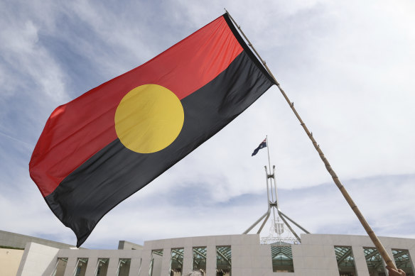 The Aboriginal flag is seen during a protest last month by Indigenous Australians on the forecourt of Parliament House in Canberra. Glen Eira Council will fly its Aboriginal and Torres Strait Islander flags at half mast on Australia Day.