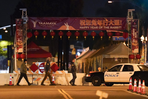 FBI agents walk near the scene where a shooting took place in Monterey Park.