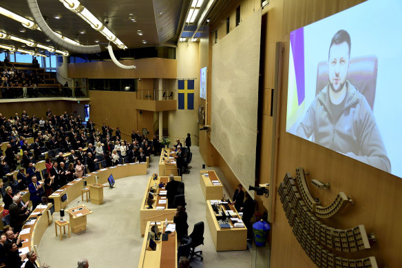 Ukraine’s President Volodymyr Zelensky receives a standing ovation as he addresses Sweden’s parliament via video link, in Stockholm.