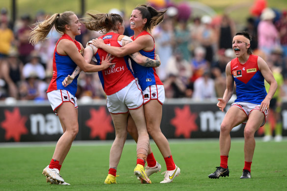 Tayla Harris and the Demons celebrate what turned out to be the match-winning goal.
