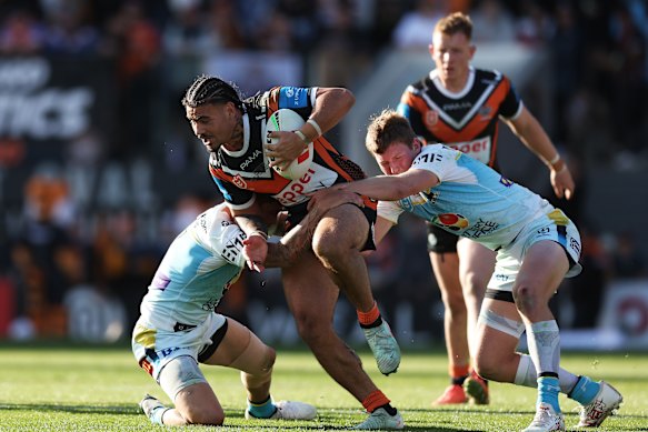 Taylan May takes on the Titans’ defence.