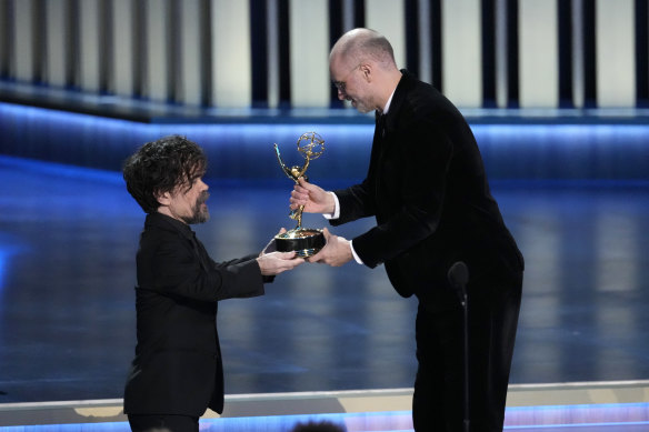 Peter Dinklage, left, presents the award for outstanding drama series to creator Jesse Armstrong.