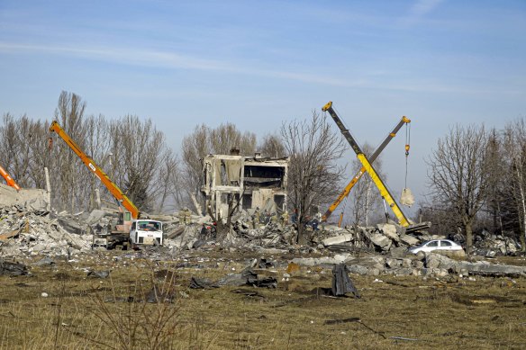Workers remove rubble after Ukrainian rocket strike in Makiivka, in the Russian-controlled Donetsk region.