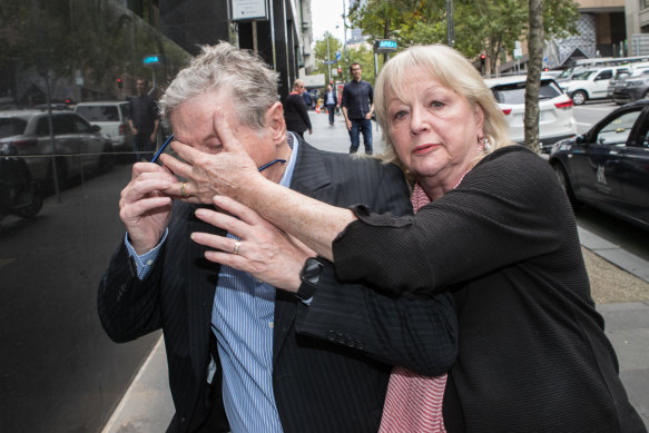 Ray Walker being protected from the cameras by a woman at IBAC hearings on Tuesday.