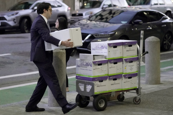 Documents related to the class-action lawsuit on behalf of investors who owned Tesla stock in August 2018 are loaded onto a cart outside of a federal courthouse in San Francisco.