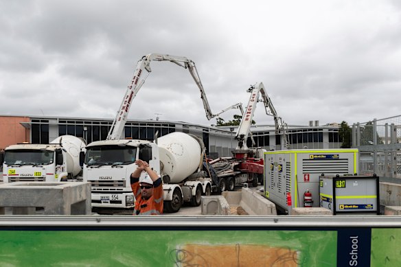 Workers fill in a huge sinkhole with cement in March last year to stabilise a two-storey building that teetered on the edge.