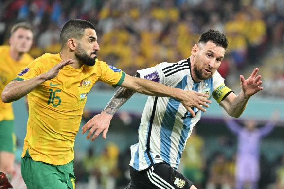 Socceroo Aziz Behich takes on Lionel Messi during the World Cup in Qatar. 