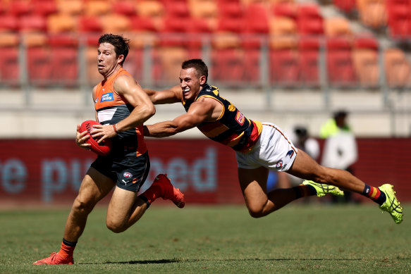Tom Doedee, right, tackles Toby Greene in round one. 