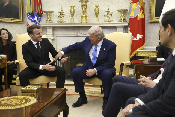 French President Emmanuel Macron speaks with US President Donald Trump as Secretary of State Marco Rubio listens during a meeting in the Oval Office.