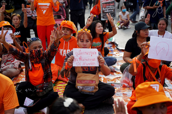 Supporters of the Move Forward party raise three-finger salutes during a rally organised by activist groups.