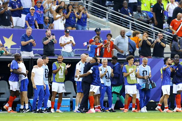 Kylian Mbappe #10 of France celebrates with Didier Deschamps after scoring the opening goal.