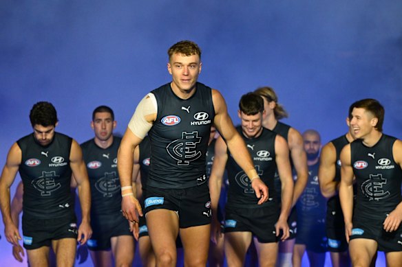 Patrick Cripps of the Blues leads the Blues out.