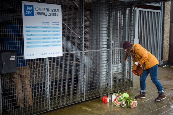 A woman lays flowers outside the scene of the deadly shooting.