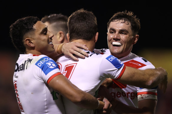 Tyrell Sloan, Ben Hunt and Kyle Flanagan celebrate a Dragons try.